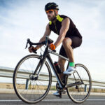 handsome young man cycling on the road 2022 12 15 18 18 17 utc